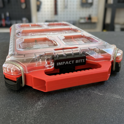 PACKOUT organizer with customizable IMPACT BITS label on a workshop background